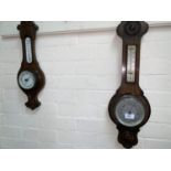 Two 1930's oak cased wall hanging aneroid barometers