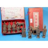Two boxed presentation sets of terracotta soldiers, four soldiers and one horse in different poses