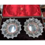 A pair of Victorian silver sweetmeat dishes with embossed and pierced decoration, cased, 7.5oz,