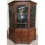 A large Georgian inlaid and crossbanded mahogany canted front full height display cabinet, the upper