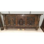 A pair of Jacobean style 19th century oak bed ends, the head extensively carved with 3 arched panels