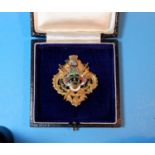 A medallion in 9 carat hallmarked gold and coloured enamel, bearing the crest of Huddersfield,