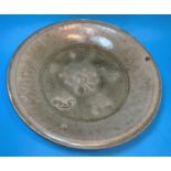A large circular early Chinese potter shallow dish with celedon glaze diameter 12"