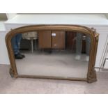 A Victorian overmantel mirror in gilt arch top frame