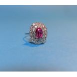 A white metal pink sapphire and diamond cluster dress ring, the central pink stone approximately 3