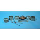 Five various silver napkin rings; a silver preserve pot lid; a pair of sugar tongs and sugar nips,