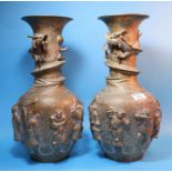 A pair of early 20th century Chinese brass baluster vases with dragon entwined necks, the bodies