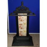 A Victorian cast iron stick stand with tile back