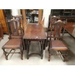 A 1930's oak canted and scalloped drop leaf dining table on barley twist legs