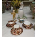 A Royal Worcester figure "The Parakeet"; a Nao figure: girl with bird; a cabinet cup and saucer