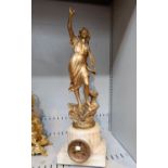 An alabaster clock case with movement surmounted by large gilded metal figure