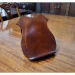 A 19th century shield shaped figured mahogany bookstand, folding easel supports, 11.5"