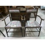 A pair of Edwardian inlaid spindle back dining chairs