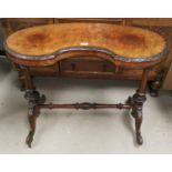 A Victorian burr walnut occasional table, kidney shaped on turned columns, splay feet and castors