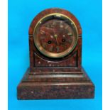 A 19th century mantel clock in red veined marble arch top case, with gilt numerals and French drum