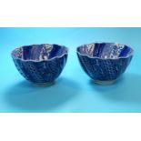 A Chinese / Japanese pair of rice bowls of spiral fluted form, decorated with alternating blue and