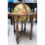 A reproduction globe on stand, with hand painted effect decoration, with zodiac signs to base