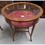 An oval Edwardian inlaid satinwood bijouterie cabinet with raised hinged glazed top, on 4 square