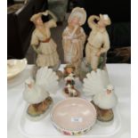 A Victorian bisque figure of a girl; 2 Victorian style figures of cyclists (a.f.); a 1950's Poole