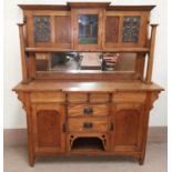 A late 19th century Arts and Crafts style oak mirror back sideboard, the raised mirrir back with
