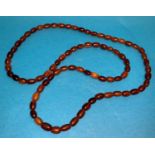 A necklace formed from amber coloured beads, 9mm, weight 43gm