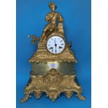 A 19th century French mantel clock in ormolu case surmounted by a reclining man in renaissance