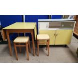 A 1950's kitchen table in yellow Formica; a similar base unit; 2 stools