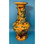 A large Chinese Sancai baluster vase decorated with dragons in relief, under yellow, green and brown