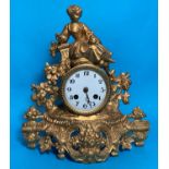 A 19th century French mantel clock in gilt metal case surmounted by a woman with dove, white