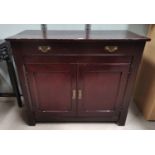 An Edwardian stained pine side cabinet with frieze drawer and double cupboard