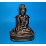 A Burmese bronze seated budda with glass eyes height 6.5"