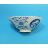A Chinese porcelain blue and white rice bowl decorated with dragons, exotic trees etc, on raised