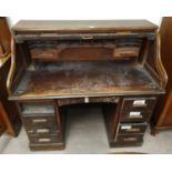 An 'S' roll top twin pedestal desk, vintage oak finish, 48"