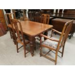 A rectangular Edwardian golden oak dining table and a set of 6 (5 + 1) similar dining chairs