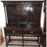 An early 20th century oak sideboard in the William and Mary style, the raised back with geometric