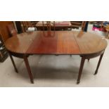 A 19th century Georgian style rounded rectangular extending dining table, 2 spare leaves, on