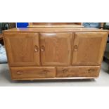 A lightwood Ercol sideboard of three cupboards and 2 drawers, length 81", depth 17"