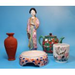 A 20th century CHinese porcelain figure of a woman holding a bird, in pink, height 12.5"; a