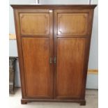 An early 20th century Georgian style part fitted mahogany double wardrobe enclose by twin panel