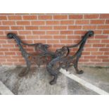 A Victorian pair of cast iron garden bench ends with griffin terminals