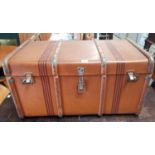 A large canvas cabin trunk, wood bound with interior shelf