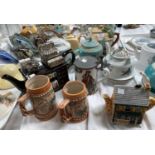 A selection of novelty and decorative teapots; steins; etc.