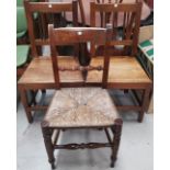 A pair of 19th century elm country made dining chairs; a similar rush seat chair; 2 wheel back