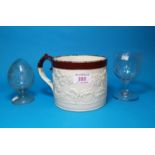 A 19th century Davenport cylindrical mug in salt glazed stoneware, with brown glazed rim,