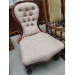 A 19th century mahogany spoon back nursing chair in pink dralon