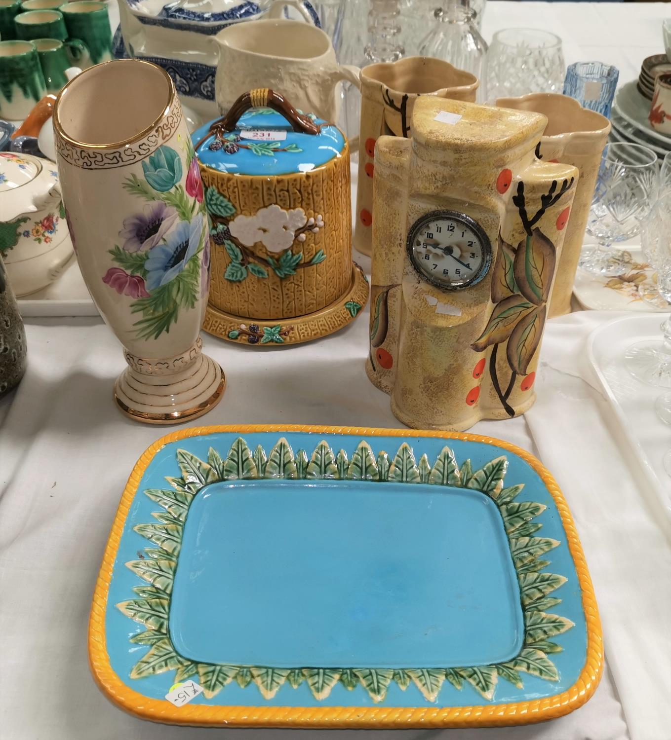 A Minton style majolica cheese dish and platter; an Art Deco pottery clock garniture; a "Tavern in
