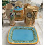 A Minton style majolica cheese dish and platter; an Art Deco pottery clock garniture; a "Tavern in