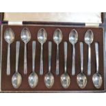 A set of 12 hallmarked silver teaspoons by Walker & Hall with square stepped terminals, Sheffield