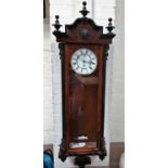 A 19th century Vienna walnut wall clock with ebonised mouldings and single weight driven movement