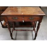 An Edwardian burr oak side table with 2 drawers, on turned legs